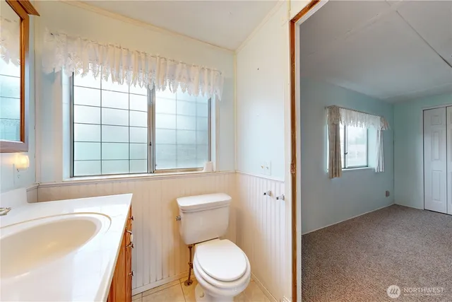 a white toilet sitting next to a bathroom sink
