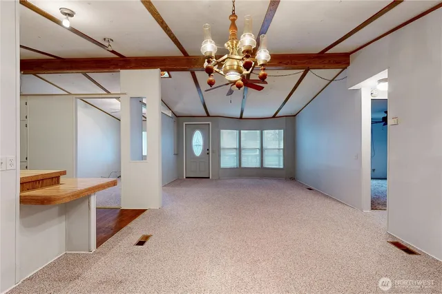 a view of a livingroom with a ceiling fan and window