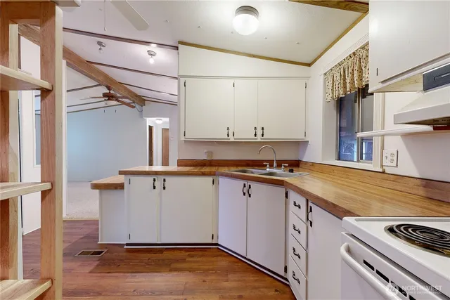 a view of a kitchen with a sink and cabinets