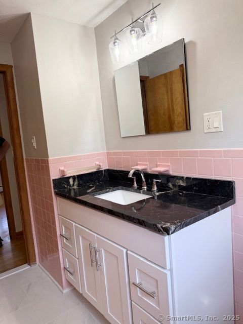 121 Pinehurst Avenue New Britain, CT 06053 - Photo 13 of 14 a bathroom with a granite countertop sink and a mirror