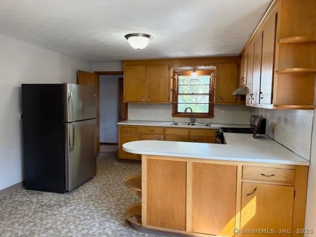 a kitchen with stainless steel appliances granite countertop a refrigerator a sink a stove a microwave and island