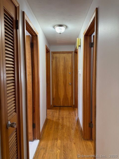 121 Pinehurst Avenue New Britain, CT 06053 - Photo 9 of 14 a view of a hallway with wooden floor and staircase