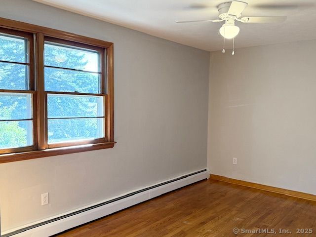 121 Pinehurst Avenue New Britain, CT 06053 - Photo 10 of 14 an empty room with wooden floor fan and windows