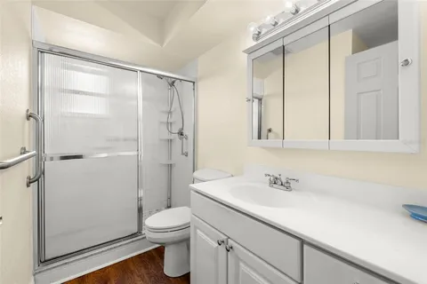 a bathroom with a sink a toilet and shower