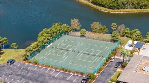 a view of a lake with a floor to ceiling windows and wooden floor