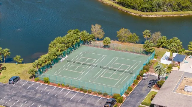 a view of a lake with a floor to ceiling windows and wooden floor