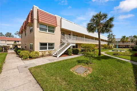 a front view of a house with a yard table and chairs