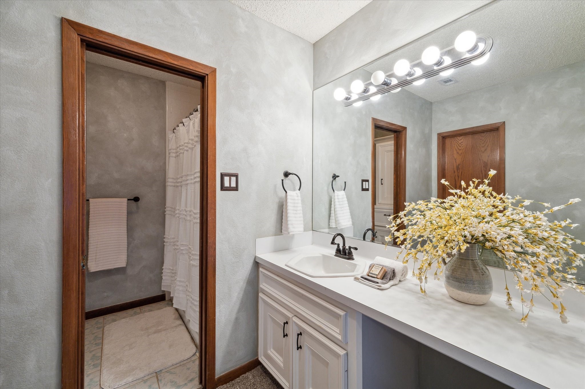 2614 Rip Van Winkle Drive Pearland, TX 77581 - Photo 23 of 31 a bathroom with a sink and a mirror