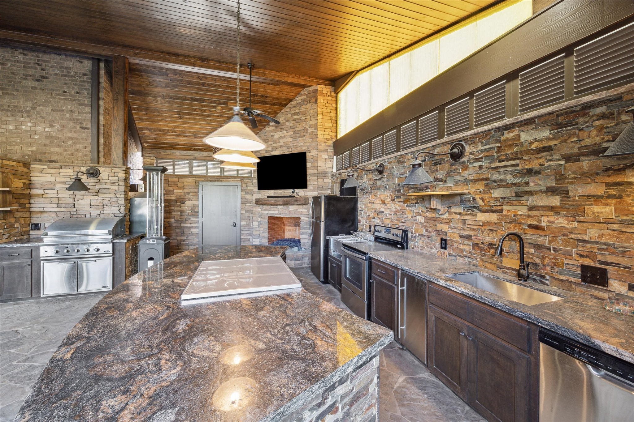 2614 Rip Van Winkle Drive Pearland, TX 77581 - Photo 25 of 31 a kitchen with stainless steel appliances kitchen island granite countertop a sink and stove top oven