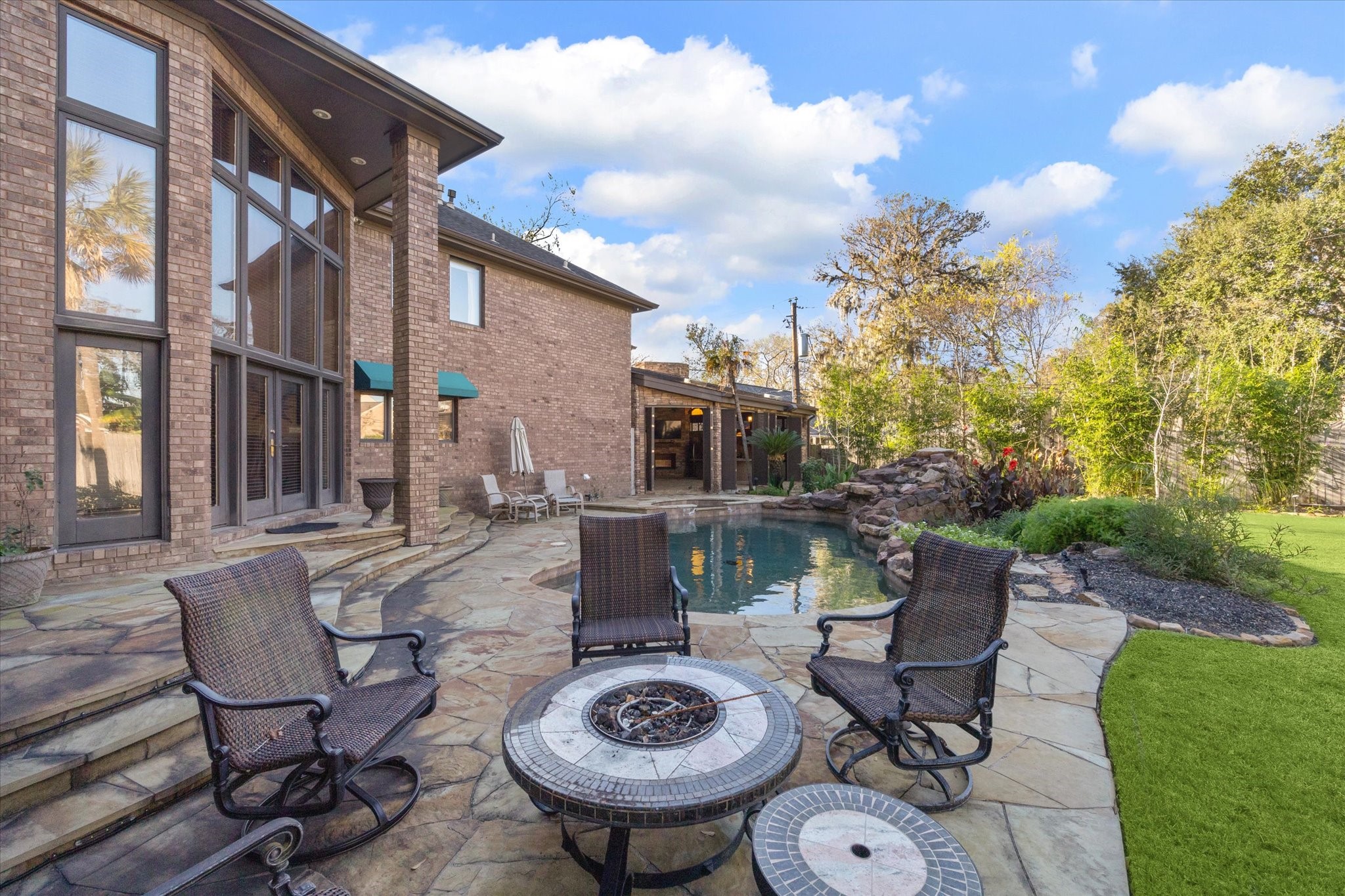 2614 Rip Van Winkle Drive Pearland, TX 77581 - Photo 27 of 31 a view of a patio with table and chairs with a barbeque grill and plants