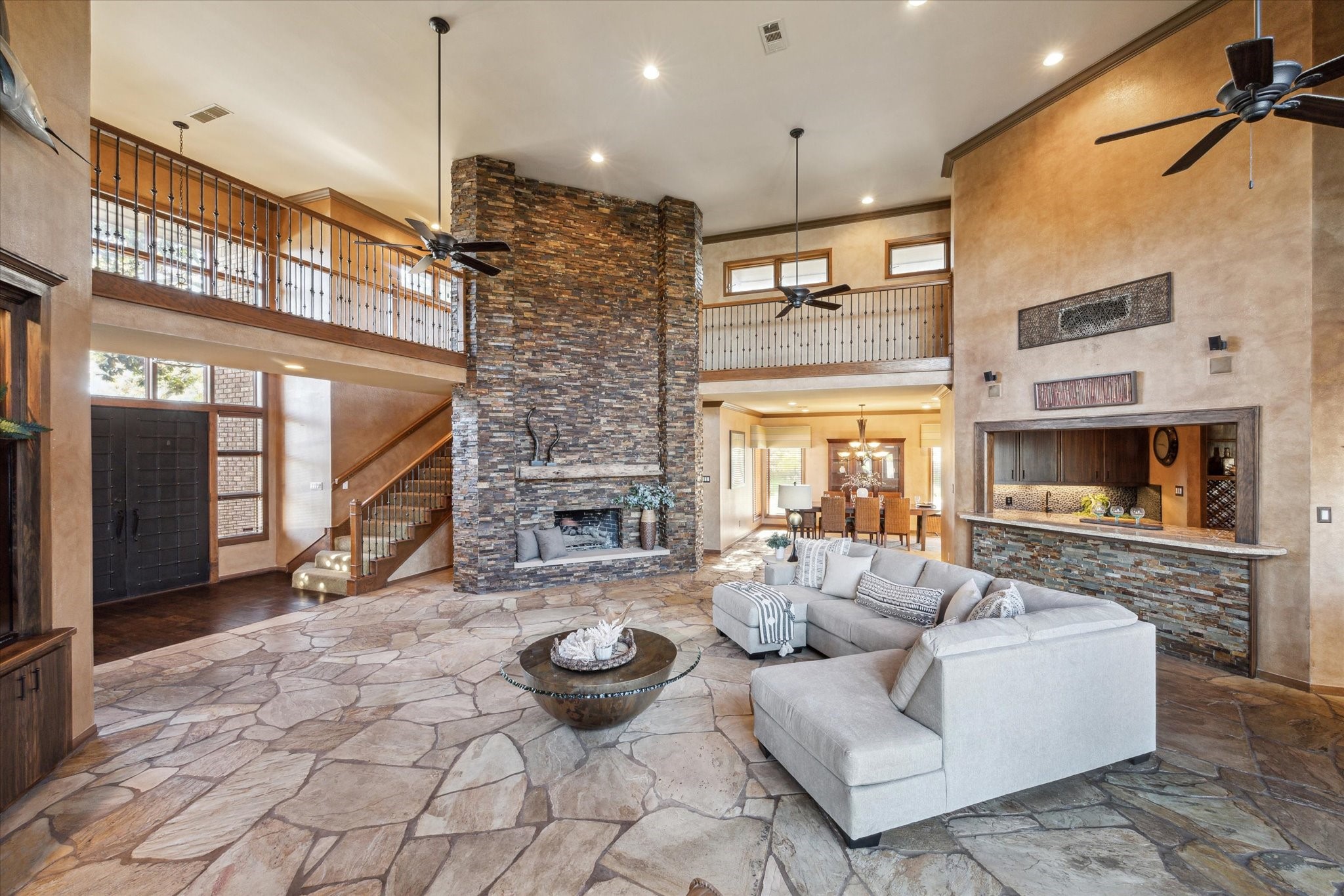 2614 Rip Van Winkle Drive Pearland, TX 77581 - Photo 7 of 31 a living room with furniture a fireplace and a chandelier