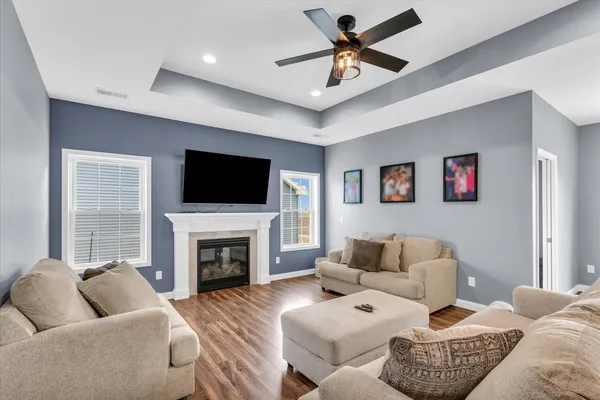 a living room with furniture a fireplace and a flat screen tv