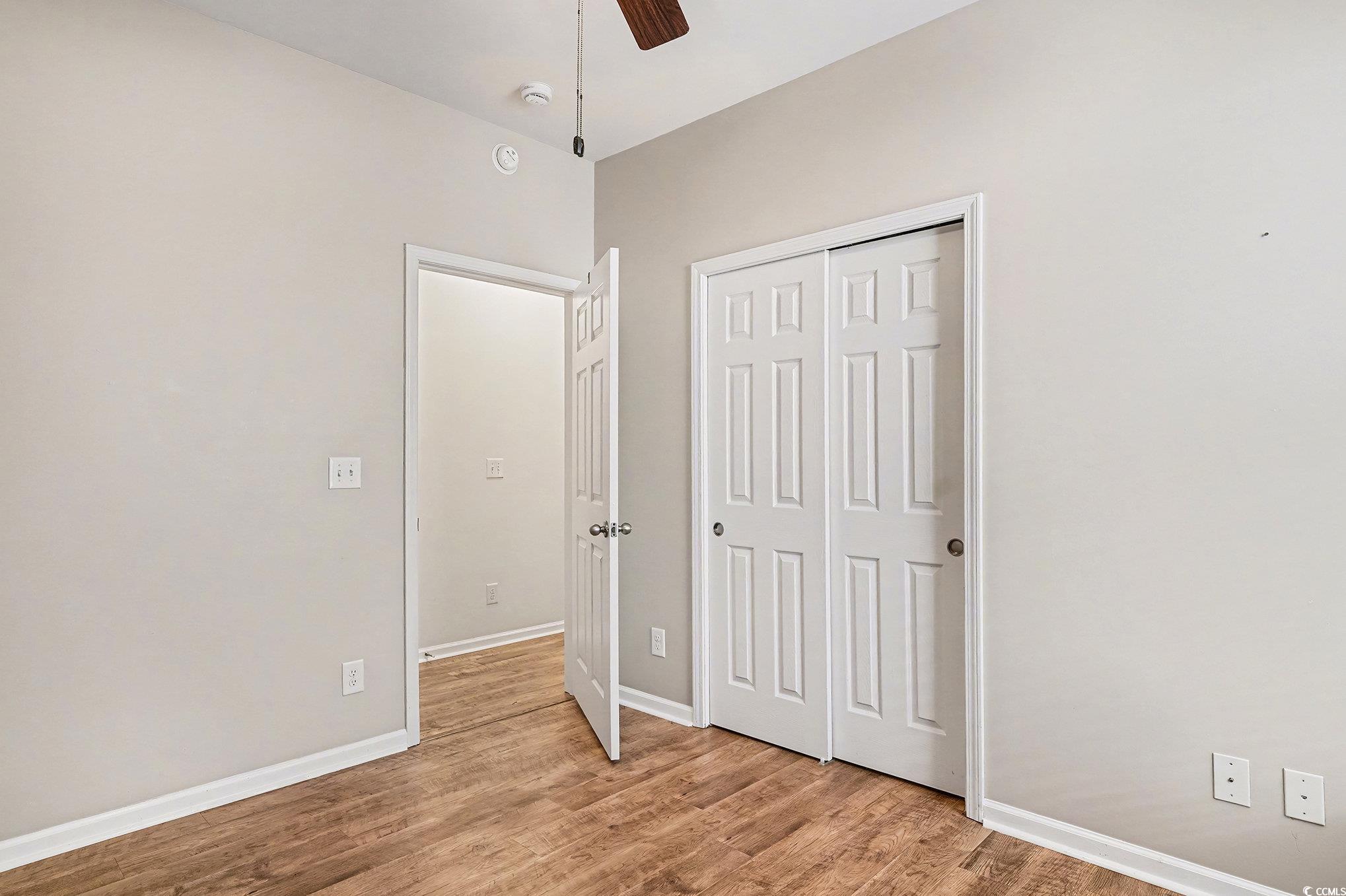 1526 Palmina Loop, Unit C Myrtle Beach, SC 29588 - Photo 24 of 34 Unfurnished bedroom with a closet, light wood-type flooring, and a ceiling fan