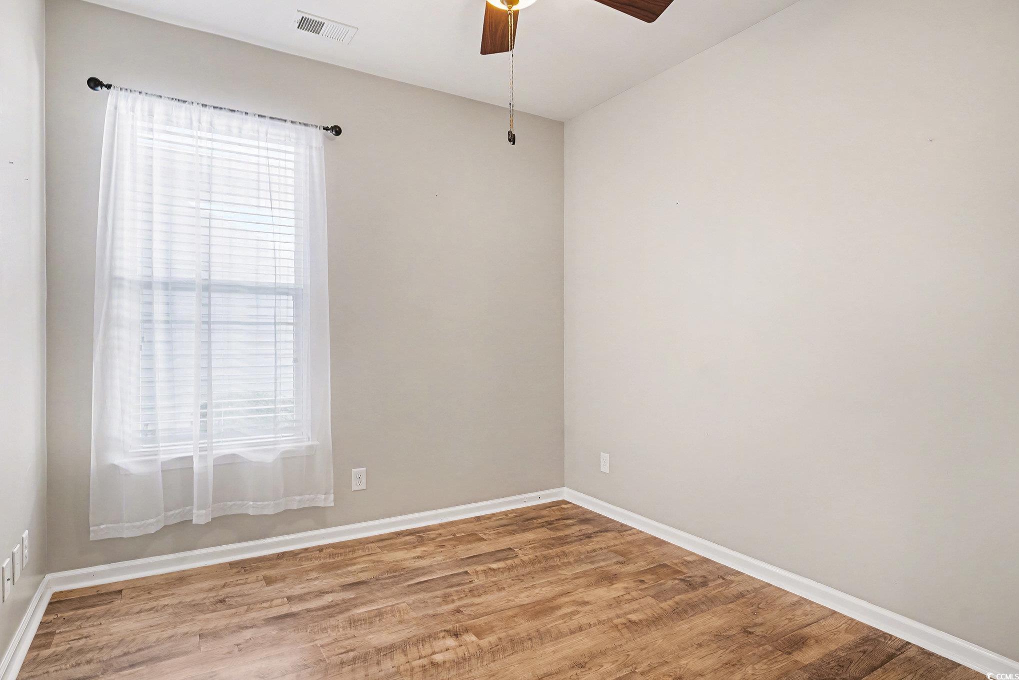 1526 Palmina Loop, Unit C Myrtle Beach, SC 29588 - Photo 25 of 34 Spare room featuring wood finished floors and a ceiling fan