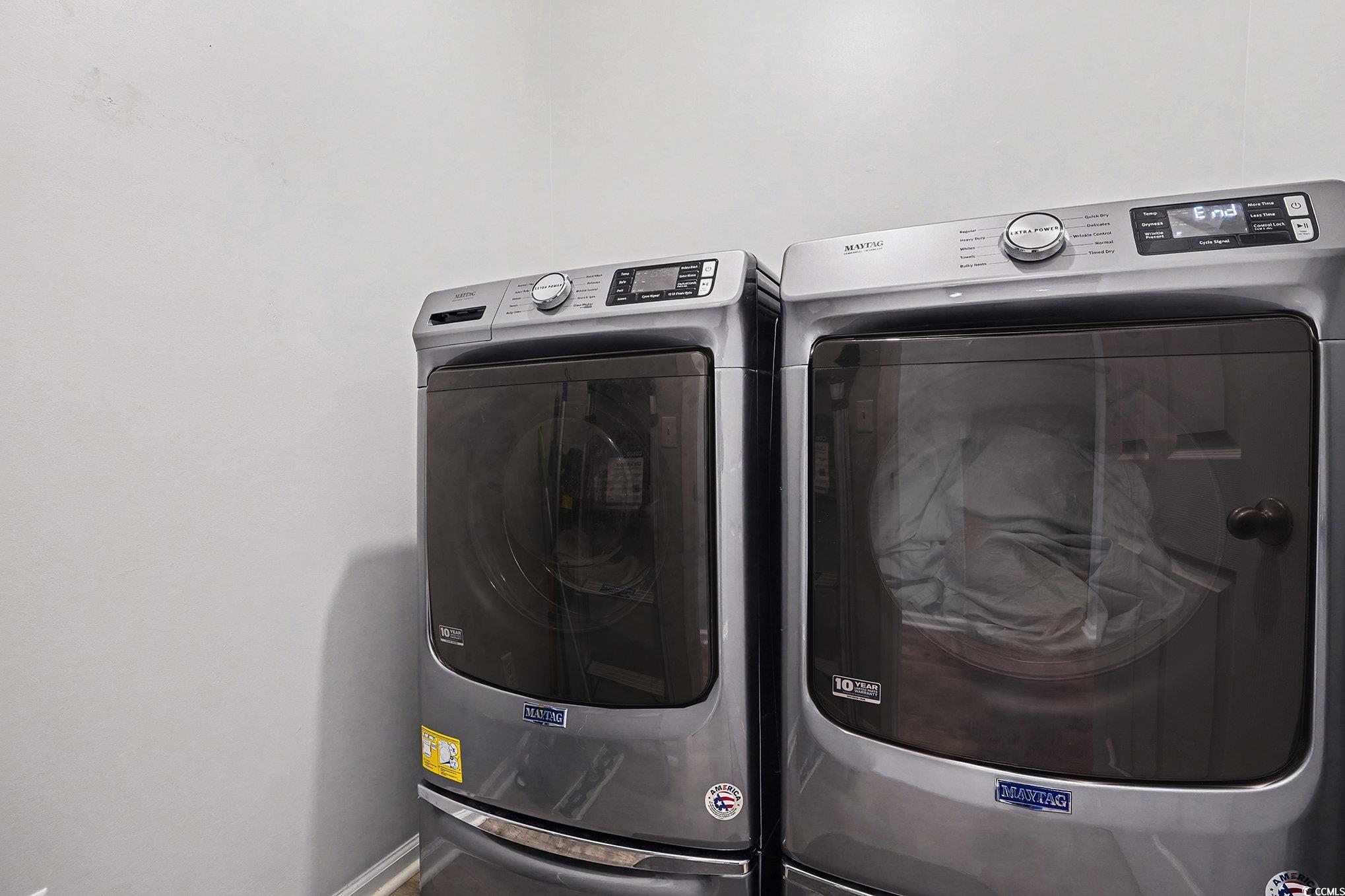 1526 Palmina Loop, Unit C Myrtle Beach, SC 29588 - Photo 26 of 34 Laundry room with washing machine and clothes dryer and baseboards
