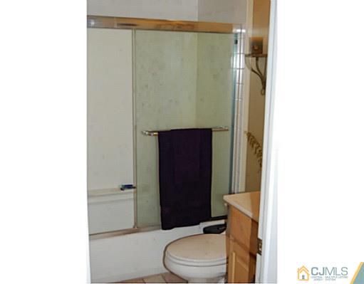 95 Winthrop Road Edison, NJ 08817 - Photo 9 of 25 a bathroom with a toilet a sink and shower