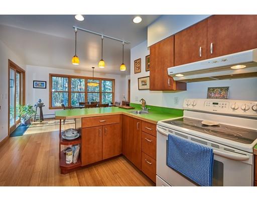 139 Brickyard Road Southampton, MA 01073 - Photo 11 of 29 a kitchen with a stove a sink and a wooden cabinets