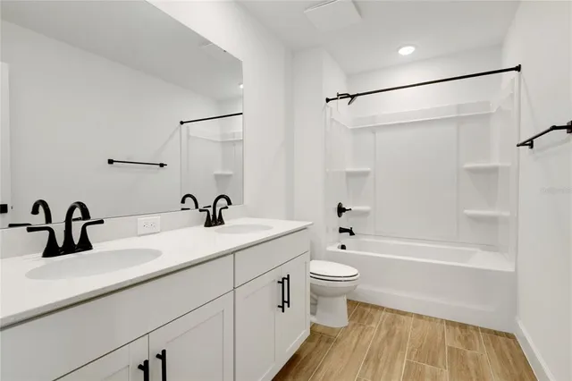 a bathroom with a sink a toilet and a bathtub