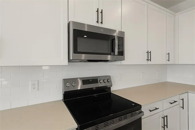 a kitchen with a stove and a microwave