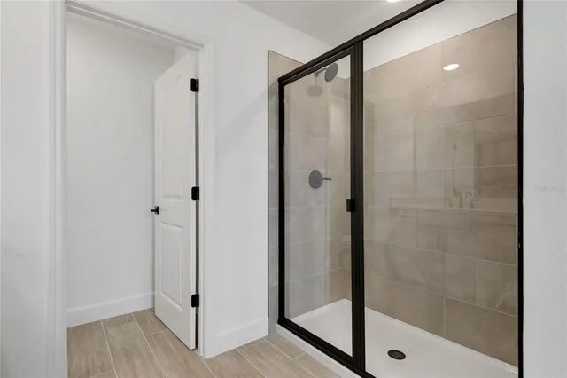 a bathroom with a glass shower door