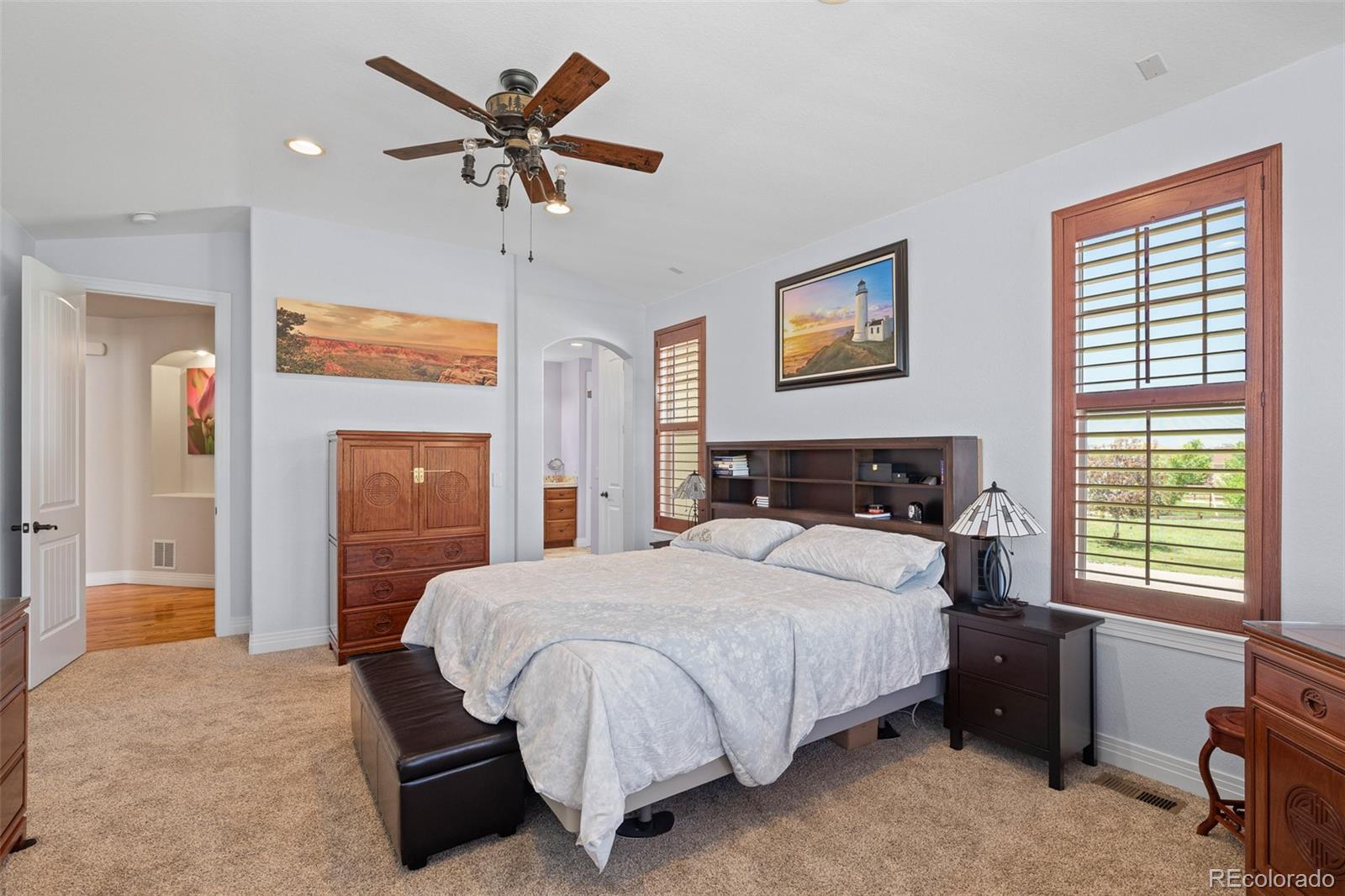 41865 East Muirfield Loop Elizabeth, CO 80107 - Photo 18 of 50 a bedroom with a bed and a chandelier