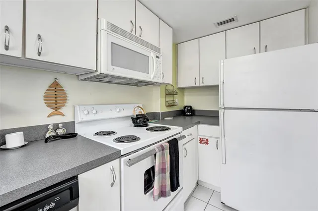 a kitchen with a sink a stove and cabinets