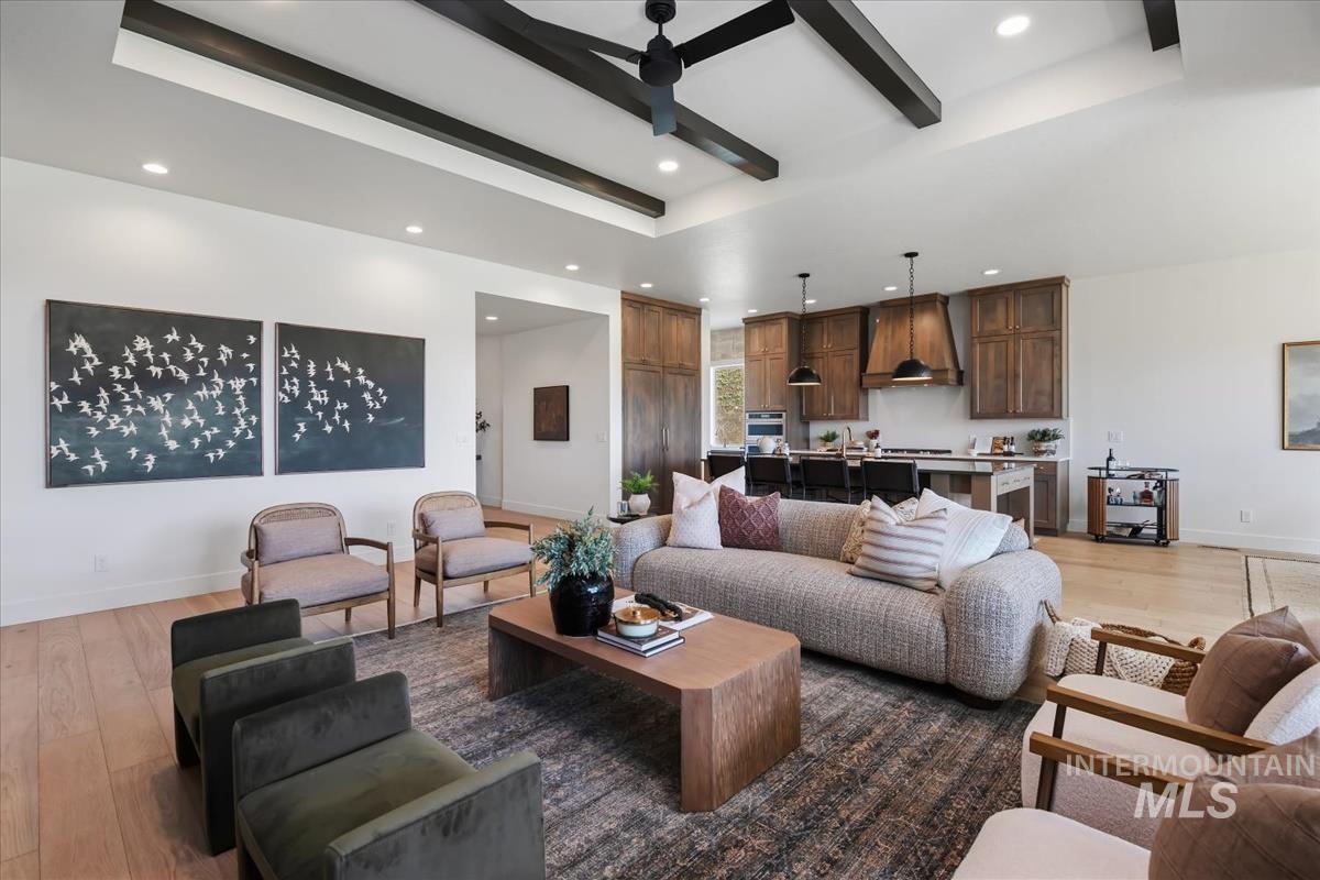 7615 Brown Way Eagle, ID 83714 - Photo 5 of 43 Open-concept living area featuring a vaulted ceiling with exposed dark wood beams and recessed lighting