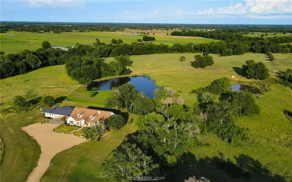 an aerial view of ocean with residential house with outdoor space