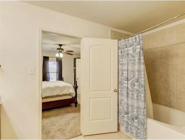 a bedroom with a bed and a shower
