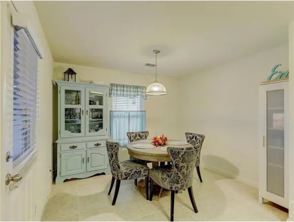 a view of a dining room with furniture and chandelier
