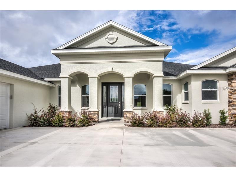 4560 Highcrest View Lady Lake, FL 32159 - Photo 1 of 1 front view of a house with potted plants