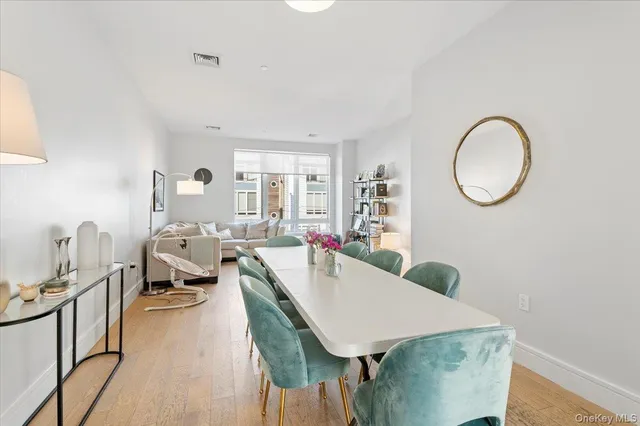 a living room with furniture a dining table and a fireplace