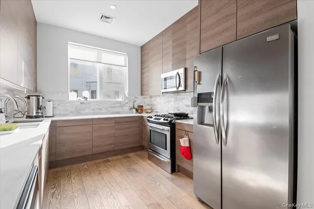 a kitchen with a refrigerator and a sink