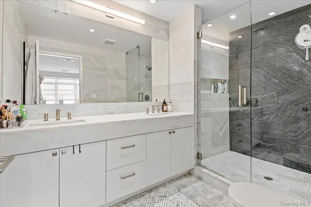 a bathroom with a shower sink and mirror