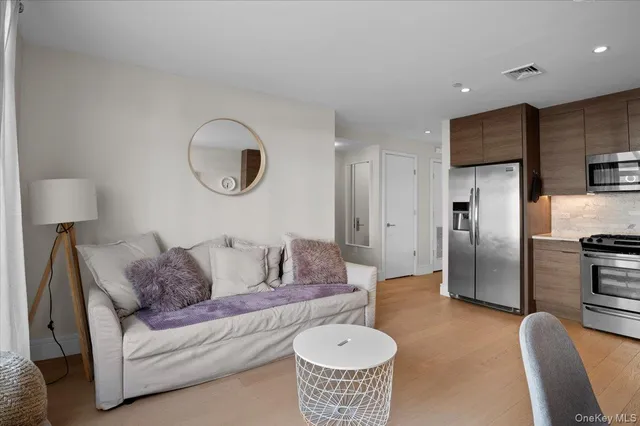 a living room with furniture and a lamp