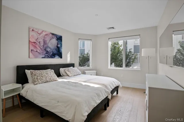 a bedroom with bed and a large window