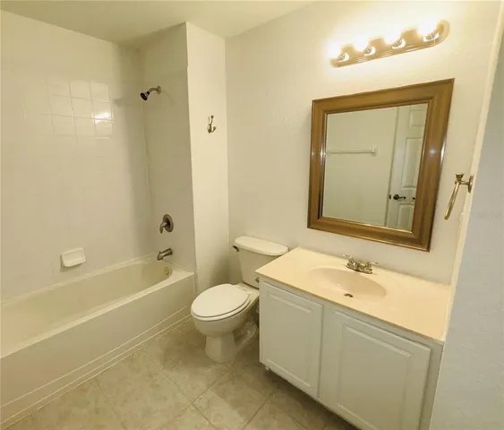 a bathroom with a sink mirror toilet and bathtub
