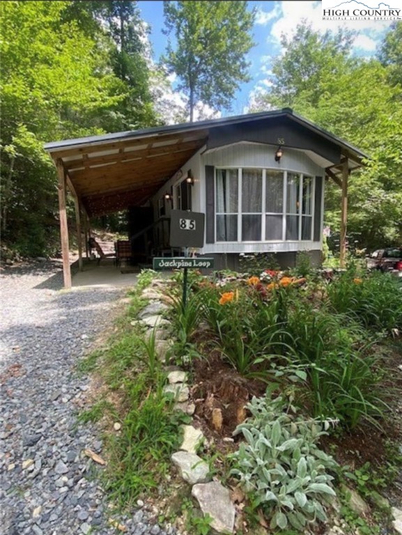 85 Jack Pine Loop Newland, NC 28657 - Photo 1 of 20 a backyard of a house with yard barbeque oven and outdoor seating