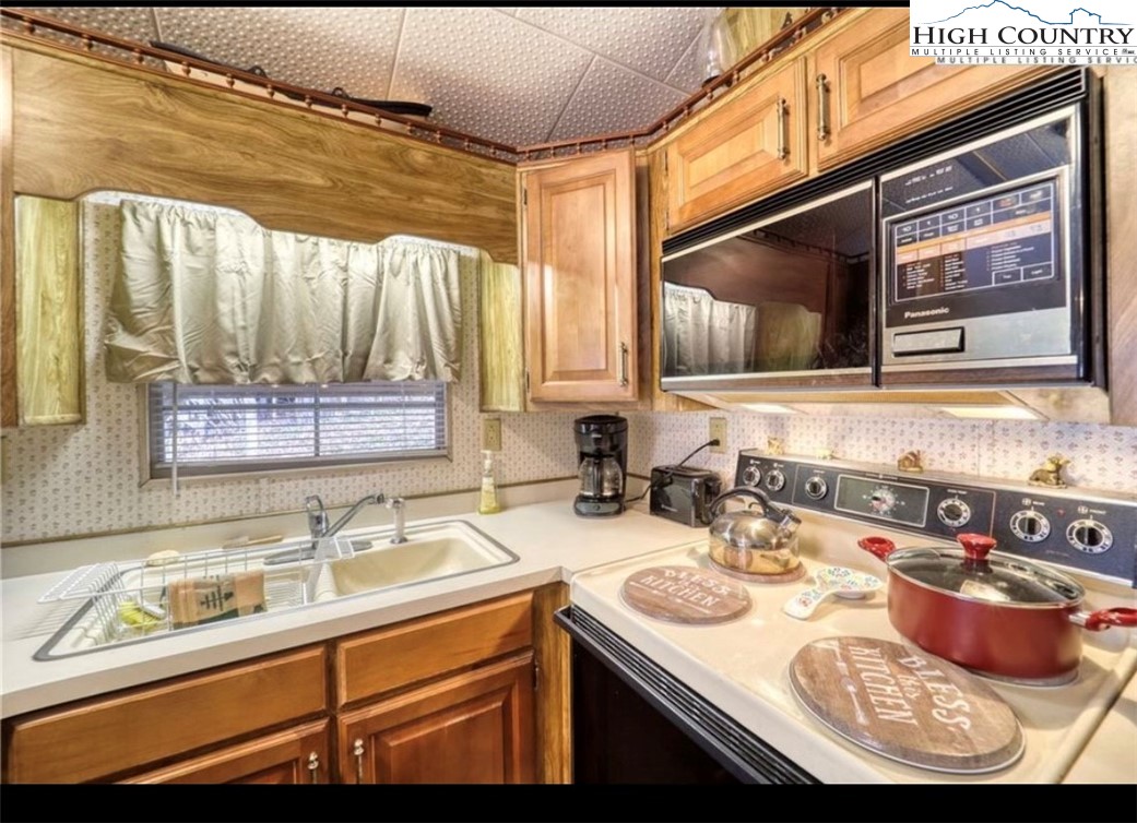 85 Jack Pine Loop Newland, NC 28657 - Photo 12 of 20 a kitchen with a sink stove and microwave