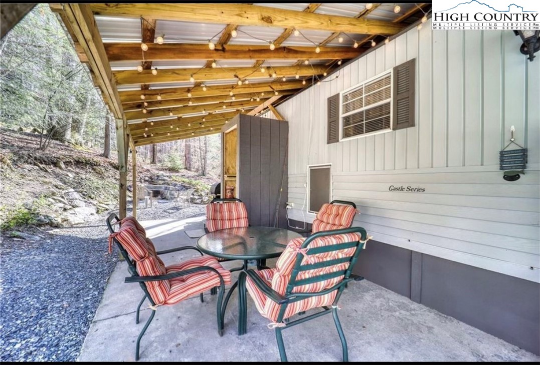 85 Jack Pine Loop Newland, NC 28657 - Photo 3 of 20 a outdoor space with patio lots of furniture and wooden floor