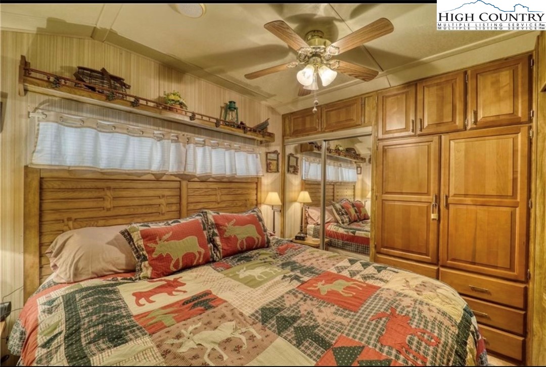 85 Jack Pine Loop Newland, NC 28657 - Photo 5 of 20 a bedroom with a bed and a chandelier