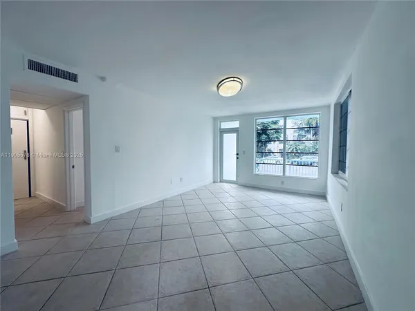 a view of an empty room with a window