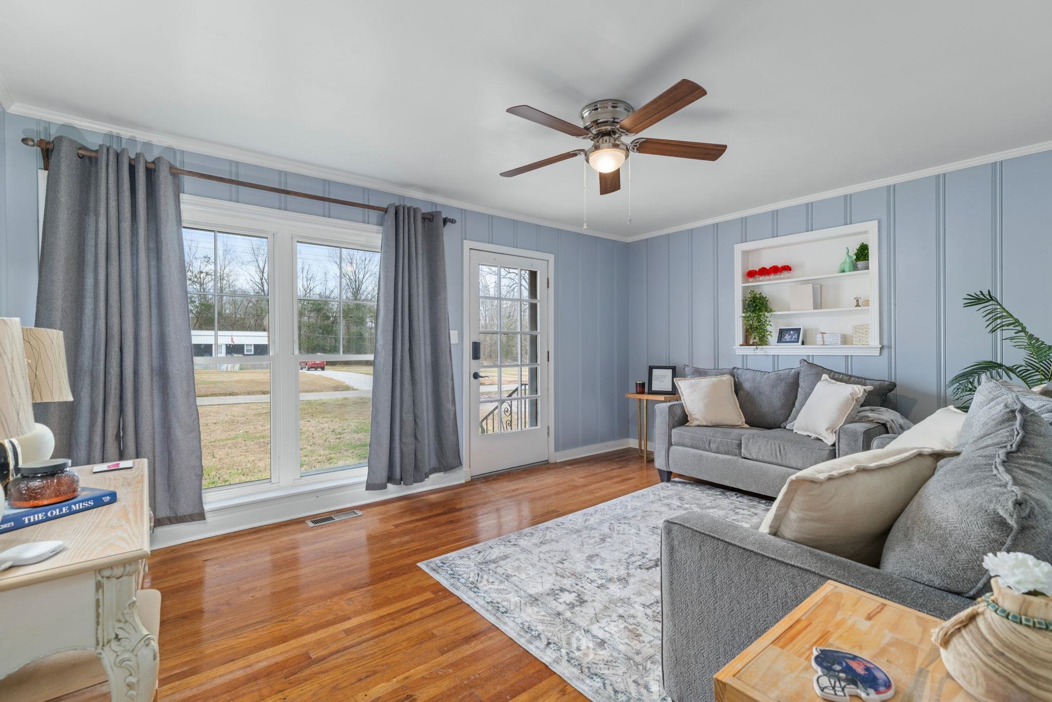 12 County Road 512 Corinth, MS 38834 - Photo 14 of 39 Living area featuring wood finished floors, a ceiling fan, and crown molding