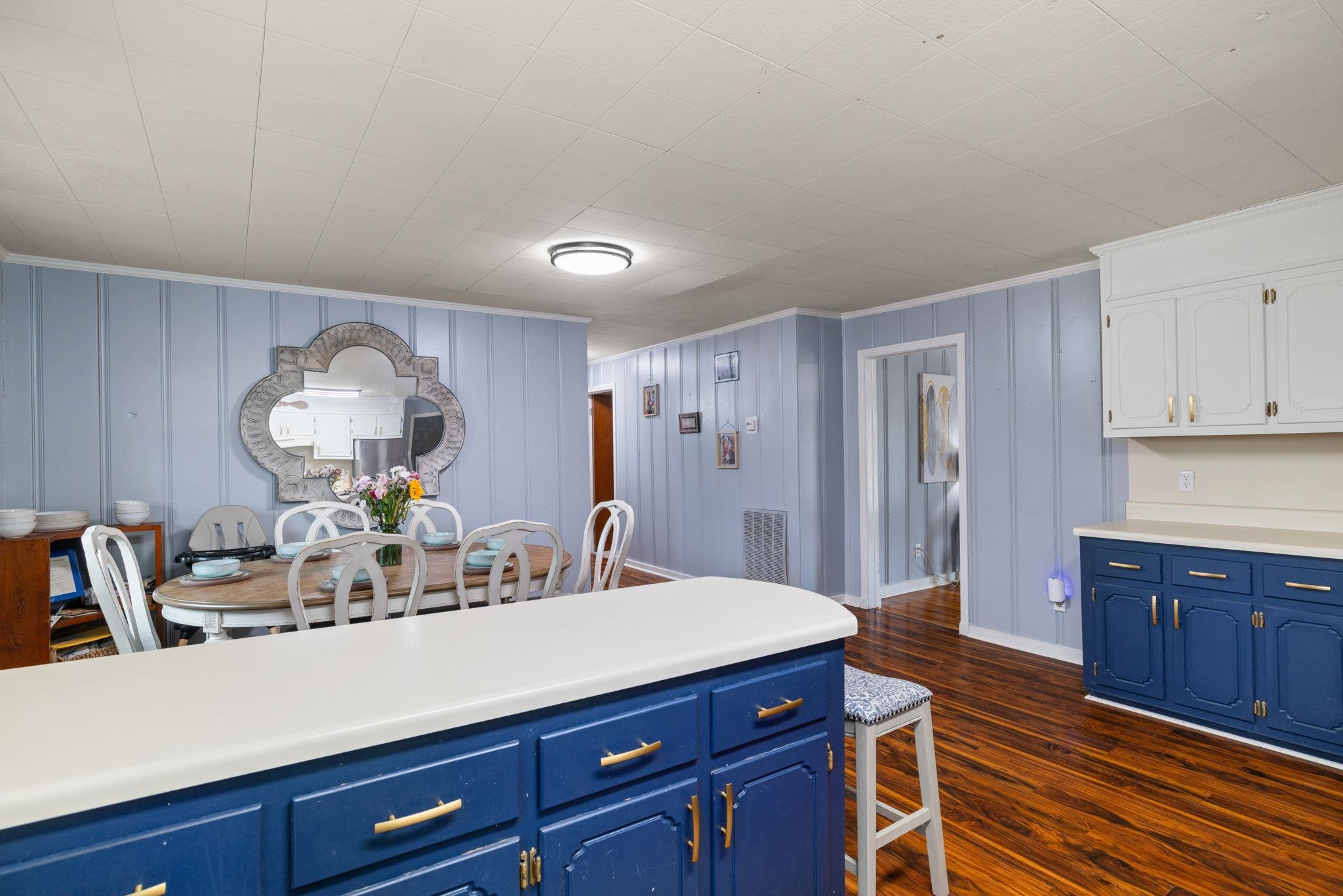 12 County Road 512 Corinth, MS 38834 - Photo 28 of 39 Kitchen with light countertops, dark wood-style flooring, two tone color scheme, and ornamental molding