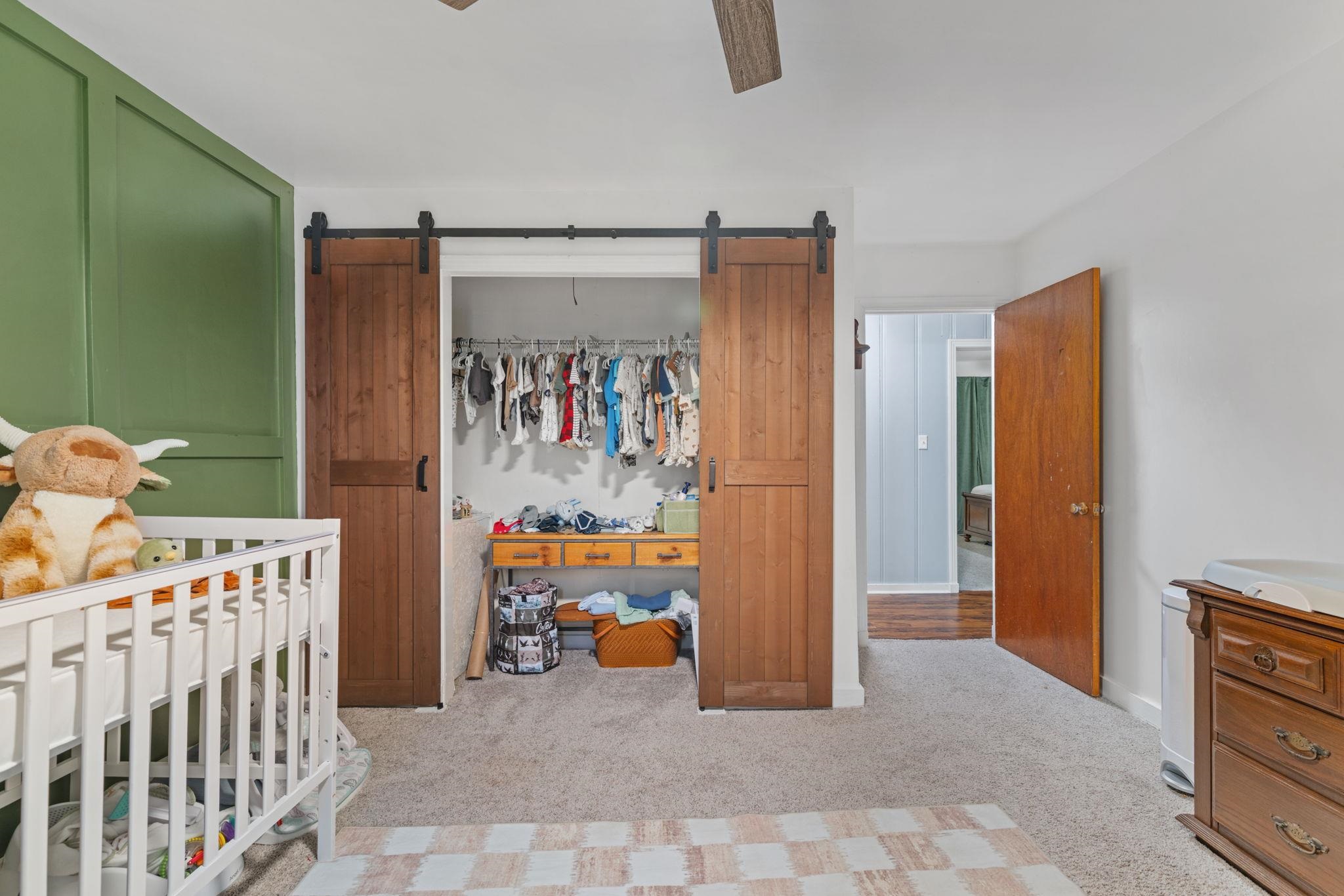 12 County Road 512 Corinth, MS 38834 - Photo 8 of 39 Bedroom with a closet, a barn door, light colored carpet, and a ceiling fan