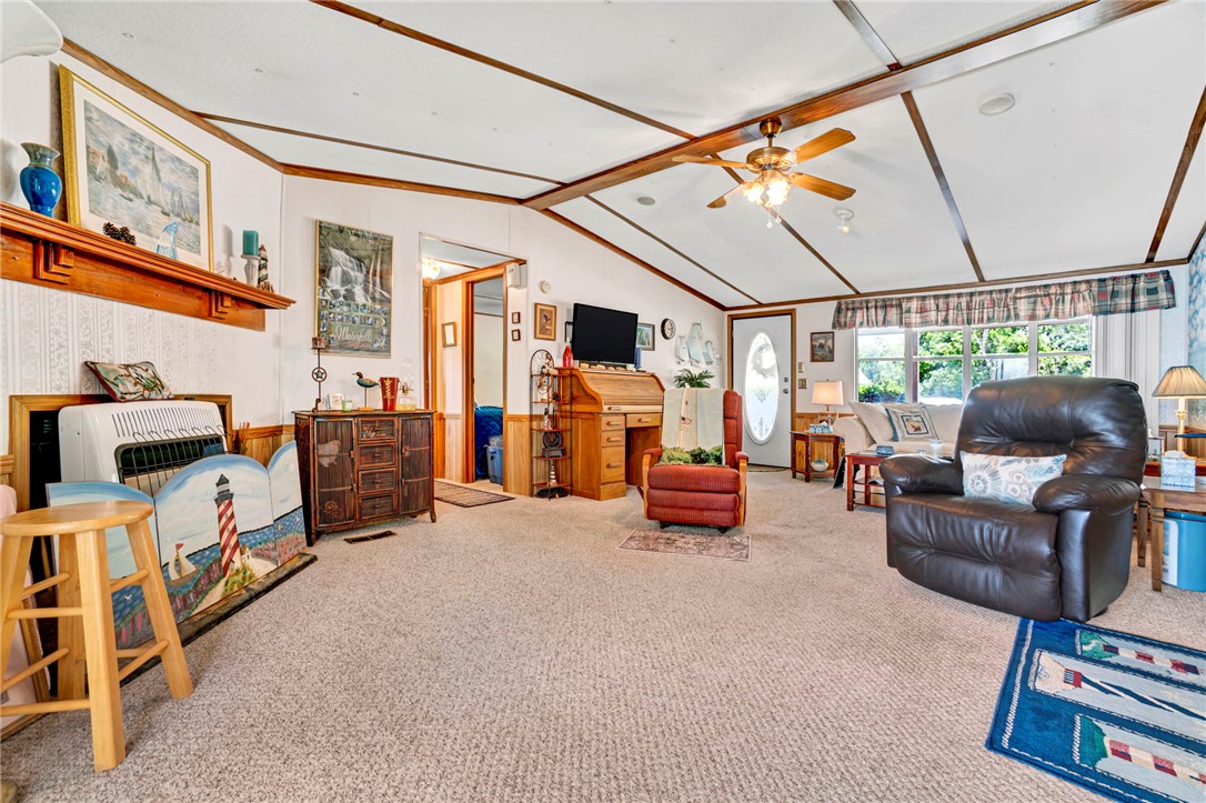225 Nicholson Cove Road Seneca, SC 29672 - Photo 10 of 22 A welcoming interior offers comfortable living with a decorative shelf and a classic ceiling fan.