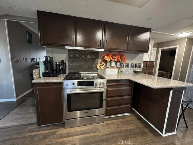 a kitchen with stainless steel appliances granite countertop a stove and a refrigerator