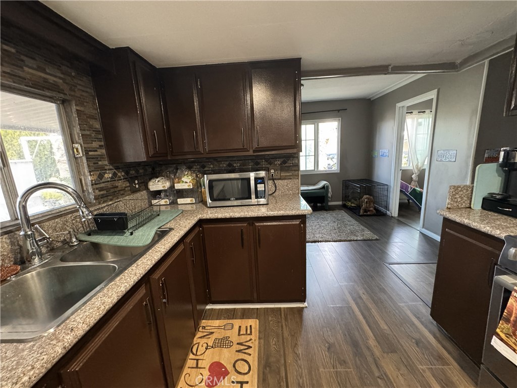 1025 South Riverside Avenue, Unit 66 Rialto, CA 92376 - Photo 13 of 53 a kitchen with granite countertop a sink dishwasher stove and cabinets