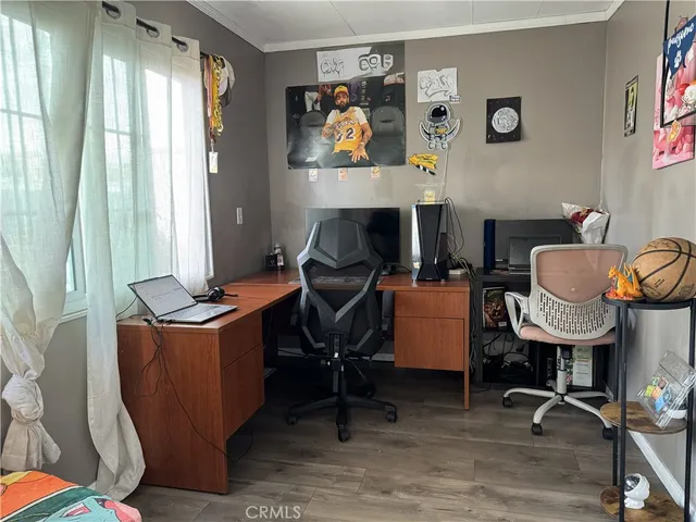 a view of a workspace with furniture and a window