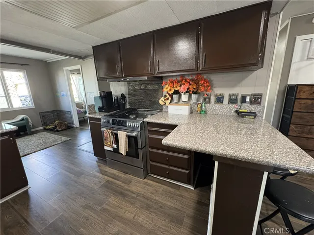 a kitchen with stainless steel appliances granite countertop a stove and a sink